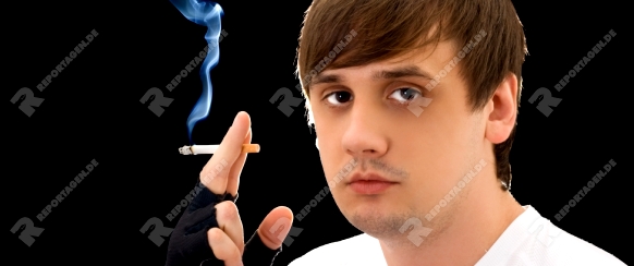 Portrait of the young man with a cigarette. Isolated